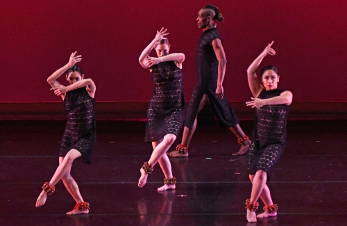 Blue13 dancers performing in all black with percussion ankle cuffs